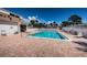 Large in-ground pool and brick patio area are surrounded by lounge chairs and palm trees at 2117 Lakewood Club S Dr # 7K, St Petersburg, FL 33712