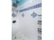 Clean, white tiled shower with decorative blue tiling and a chrome shower head at 2117 Lakewood Club S Dr # 7K, St Petersburg, FL 33712