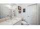 Bright bathroom featuring sleek vanity, framed mirror, walk-in shower, and decor at 22294 Storybook Cabin Way, Land O Lakes, FL 34637