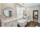 Bright bathroom features a soaking tub, double vanity, decorative mirrors and light fixtures at 22294 Storybook Cabin Way, Land O Lakes, FL 34637