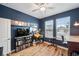 Charming bedroom with beautiful blue walls, wood floors, large TV, and natural light at 22294 Storybook Cabin Way, Land O Lakes, FL 34637