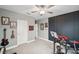 Comfortable bedroom with a decorative accent wall and musical instruments at 22294 Storybook Cabin Way, Land O Lakes, FL 34637