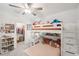 bedroom featuring bunkbeds, desk, shelving and a view into the walk in closet at 22294 Storybook Cabin Way, Land O Lakes, FL 34637