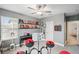 Inviting bedroom with shelves, musical instruments, and a ceiling fan at 22294 Storybook Cabin Way, Land O Lakes, FL 34637