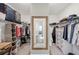 Spacious walk-in closet featuring shelving units and a full-length mirror at 22294 Storybook Cabin Way, Land O Lakes, FL 34637