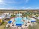 Aerial view of community featuring large swimming pool, splash pad, and various lounge seating areas for relaxation at 22294 Storybook Cabin Way, Land O Lakes, FL 34637