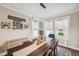 Elegant dining room with a long wooden table, decorative runner, sheer curtains, and modern lighting at 22294 Storybook Cabin Way, Land O Lakes, FL 34637