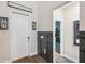 Entryway featuring decorative wall accents, a white front door, and wood look floors at 22294 Storybook Cabin Way, Land O Lakes, FL 34637