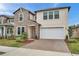 Charming two-story home with a brick driveway, stone accents, and a well-manicured lawn at 22294 Storybook Cabin Way, Land O Lakes, FL 34637