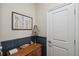 Stylish hallway with elegant wainscoting, a wooden table, and decorative artwork at 22294 Storybook Cabin Way, Land O Lakes, FL 34637