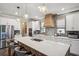 Modern kitchen boasts a large island with bar seating, stainless steel appliances, and stylish pendant lighting at 22294 Storybook Cabin Way, Land O Lakes, FL 34637