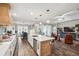 An open-concept kitchen with stainless steel appliances, island seating, and a view of the dining and living areas at 22294 Storybook Cabin Way, Land O Lakes, FL 34637