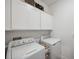 Functional laundry room featuring a white washer and dryer at 22294 Storybook Cabin Way, Land O Lakes, FL 34637