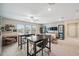 Spacious living room with neutral colors, bookshelves, TVs, tables, and lots of natural light at 22294 Storybook Cabin Way, Land O Lakes, FL 34637