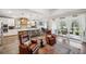 Open-concept living space with a kitchen island, a cozy seating area, and a view of the outdoor patio at 22294 Storybook Cabin Way, Land O Lakes, FL 34637