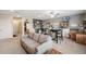 Spacious living room with neutral colors, bookshelves, tables, and a comfortable sofa at 22294 Storybook Cabin Way, Land O Lakes, FL 34637