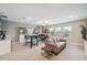 Spacious living room with neutral colors, bookshelves, tables, and lots of natural light at 22294 Storybook Cabin Way, Land O Lakes, FL 34637