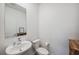 Bright powder room featuring sleek vanity, framed mirror, and decor at 22294 Storybook Cabin Way, Land O Lakes, FL 34637