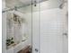 Modern tiled shower features glass doors and hanging plants at 22294 Storybook Cabin Way, Land O Lakes, FL 34637