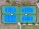 Aerial view of four tennis and basketball courts in a fenced complex, providing recreational opportunities at 22294 Storybook Cabin Way, Land O Lakes, FL 34637