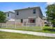 Fenced backyard featuring a patio, barbecue, and lush green grass, providing a private and enjoyable outdoor space at 2449 Moon Shadow Rd, New Port Richey, FL 34655