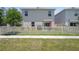 Fenced backyard featuring a patio, barbecue, and lush green grass, providing a private and enjoyable outdoor space at 2449 Moon Shadow Rd, New Port Richey, FL 34655