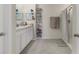 Bright bathroom featuring a dual sink vanity and a shower with neutral tile at 2449 Moon Shadow Rd, New Port Richey, FL 34655