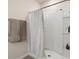 Bright bathroom featuring a walk-in shower with white tiling and towel rack at 2449 Moon Shadow Rd, New Port Richey, FL 34655