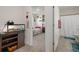 Cozy bedroom leading to a bathroom, view to the bed and decorated walls at 2449 Moon Shadow Rd, New Port Richey, FL 34655
