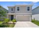 Charming two-story home with a two-car garage and well-maintained landscaping at 2449 Moon Shadow Rd, New Port Richey, FL 34655