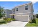 View of the house and the surrounding area with the gray house and a big driveway at 2449 Moon Shadow Rd, New Port Richey, FL 34655