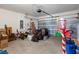 Spacious garage with ample storage, including a garage door, ladder, and various storage bins and boxes at 2449 Moon Shadow Rd, New Port Richey, FL 34655
