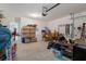 Spacious garage with ample storage, including a chest freezer, boxes, shelving units, and a garage door opener at 2449 Moon Shadow Rd, New Port Richey, FL 34655