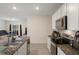 Modern kitchen features granite counters, stainless appliances and an open plan to living space at 2449 Moon Shadow Rd, New Port Richey, FL 34655