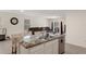 Kitchen island with gray/black marbled granite countertops, stainless steel sink, and white cabinets at 2449 Moon Shadow Rd, New Port Richey, FL 34655