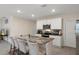 Kitchen island with white cabinets, and gray/black marbled granite countertops with stainless steel appliances at 2449 Moon Shadow Rd, New Port Richey, FL 34655