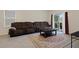 Comfortable living room with neutral walls, large sofas, a decorative rug, and modern tiled flooring at 2449 Moon Shadow Rd, New Port Richey, FL 34655