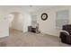 Cozy living room with neutral walls, large window, pet crate and modern tiled flooring at 2449 Moon Shadow Rd, New Port Richey, FL 34655