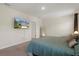 Bedroom with a mounted TV and neutral carpet and walls at 2449 Moon Shadow Rd, New Port Richey, FL 34655