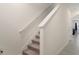 Carpeted staircase with a white handrail and neutral walls at 2449 Moon Shadow Rd, New Port Richey, FL 34655
