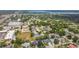 High-angle aerial view featuring a mix of commercial buildings and residential properties with a waterfront backdrop at 2667 Aspen Ct, Palm Harbor, FL 34684