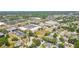 Detailed aerial view of a mixed-use area combining retail spaces with residential neighborhoods surrounded by green spaces at 2667 Aspen Ct, Palm Harbor, FL 34684