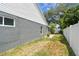 Side yard features well-maintained lawn and a white picket fence for privacy at 2667 Aspen Ct, Palm Harbor, FL 34684