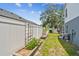Well-maintained backyard with raised garden beds, white fence, and plants at 2667 Aspen Ct, Palm Harbor, FL 34684