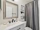 Bathroom with a gray vanity, matte black faucet, and shower at 2667 Aspen Ct, Palm Harbor, FL 34684
