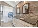Updated bathroom featuring double sinks, stylish mirrors, and a shower with a curtain at 2667 Aspen Ct, Palm Harbor, FL 34684