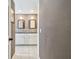 Bathroom view from a hallway with a double sink vanity and tiled floors at 2667 Aspen Ct, Palm Harbor, FL 34684