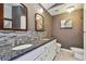 Contemporary bathroom with double sinks, decorative backsplash, and modern fixtures at 2667 Aspen Ct, Palm Harbor, FL 34684
