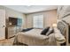 Bedroom featuring neutral walls, plush queen bed, and media center at 2667 Aspen Ct, Palm Harbor, FL 34684