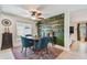 Cozy dining area with a decorative wall with rustic shelves and a ceiling fan at 2667 Aspen Ct, Palm Harbor, FL 34684